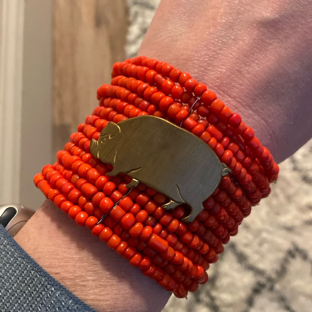 Red beaded bracelet with gold pig